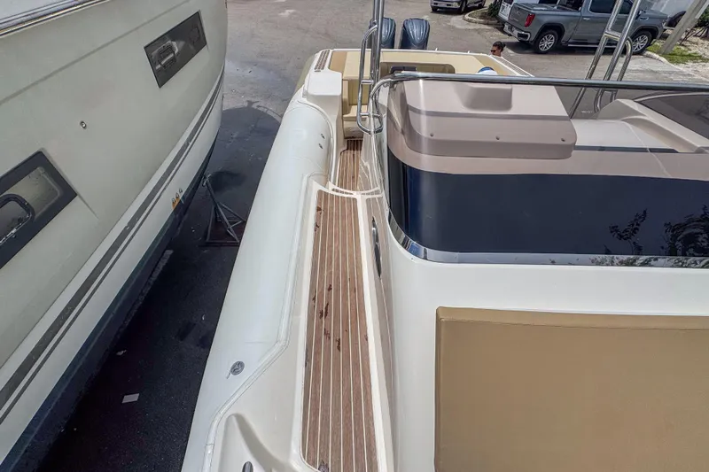  Yacht Photos Pics 2023 Tender Impertus 36 boat docked beside another vessel, showcasing sleek design.