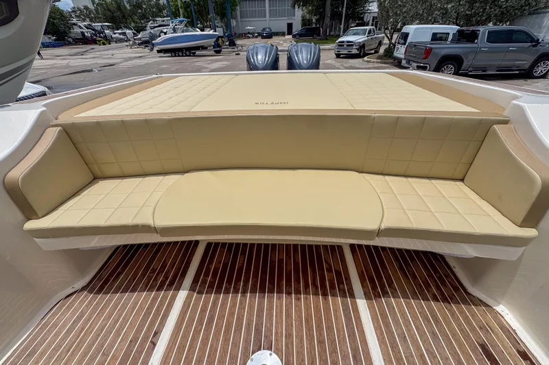  Yacht Photos Pics Luxurious seating on 2023 Tender Impertus 36 boat, featuring beige cushioned upholstery.