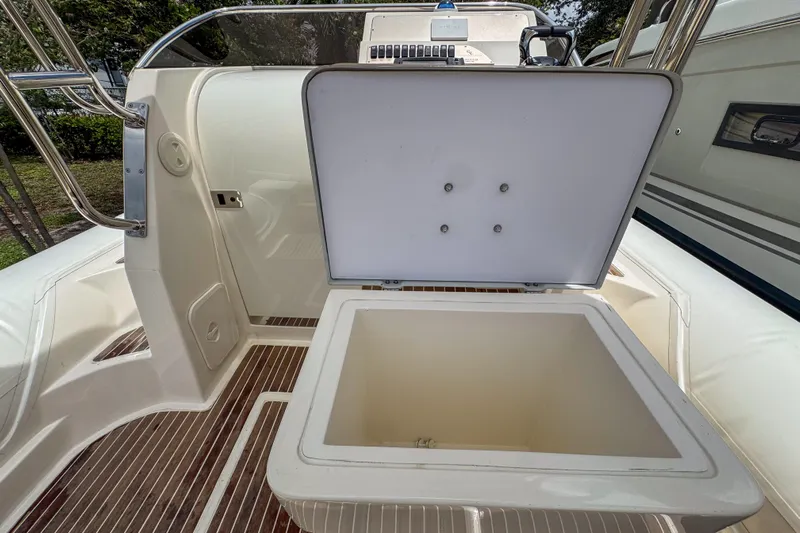  Yacht Photos Pics Open storage compartment on 2023 Tender Impertus 36 boat, featuring sleek design and wood flooring.