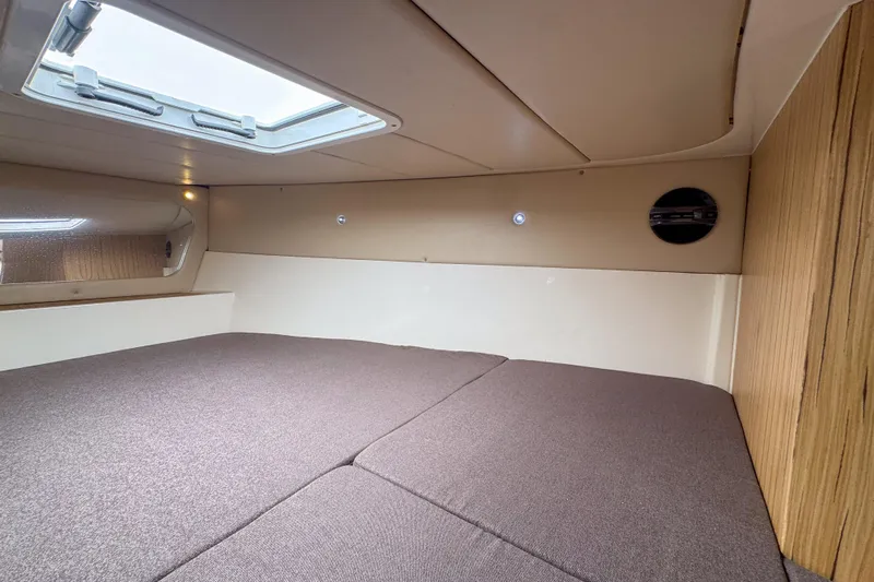  Yacht Photos Pics Cozy interior cabin of 2023 Tender Impertus 36 with skylight and wood accents.