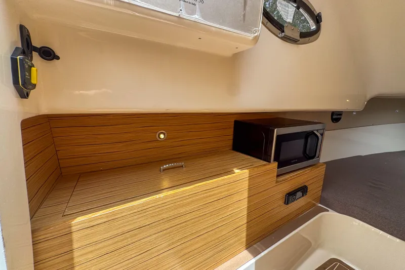  Yacht Photos Pics 2023 Tender Impertus 36 interior with wood finish and built-in microwave.