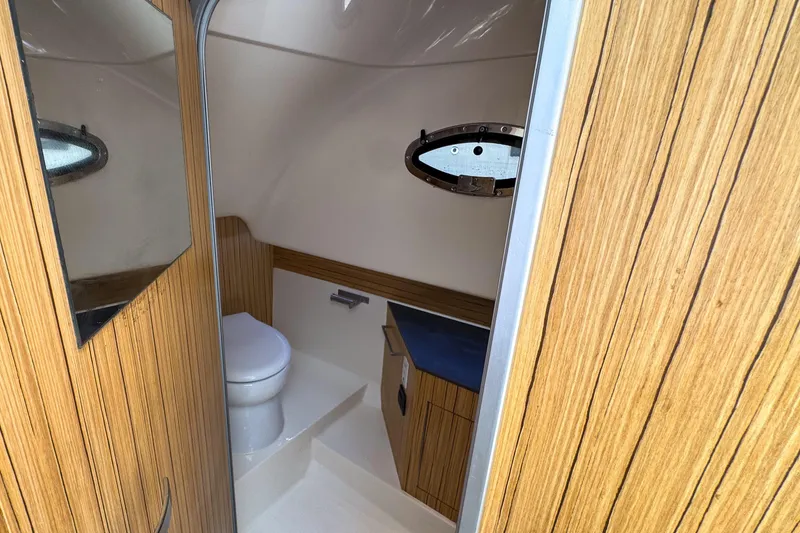  Yacht Photos Pics 2023 Tender Impertus 36 boat interior with wooden finish and compact bathroom.