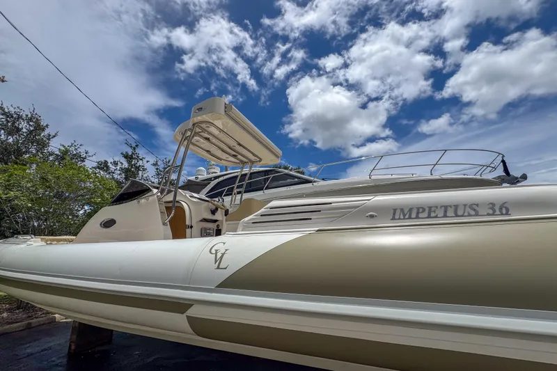  Yacht Photos Pics 2023 Tender Impertus 36 boat under a vibrant blue sky with clouds.