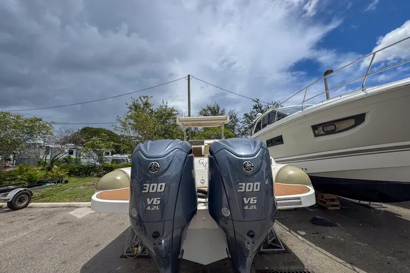  Yacht Photos Pics 2023 Tender Impertus 36 with dual 300 V6 outboard engines, parked outdoors.