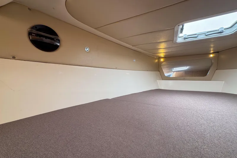 Yacht Photos Pics Interior cabin of 2023 Tender Impertus 36, featuring a cozy sleeping area and window.