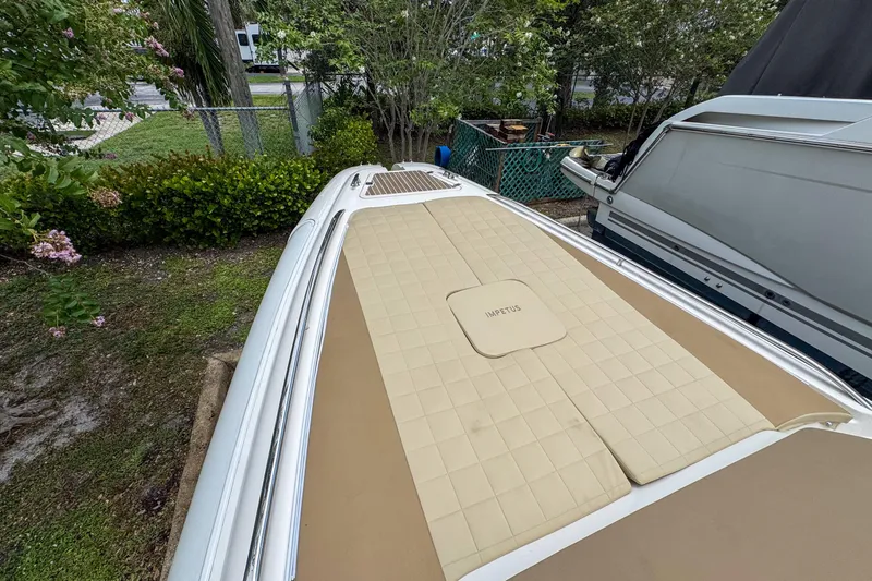  Yacht Photos Pics 2023 Tender Impertus 36 boat with beige deck, parked outdoors.