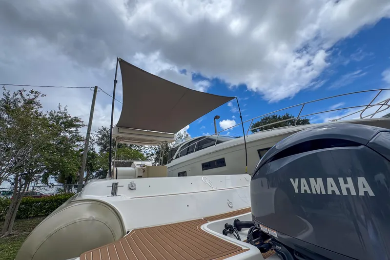  Yacht Photos Pics 2023 Tender Impertus 36 boat with Yamaha engine under a cloudy sky.
