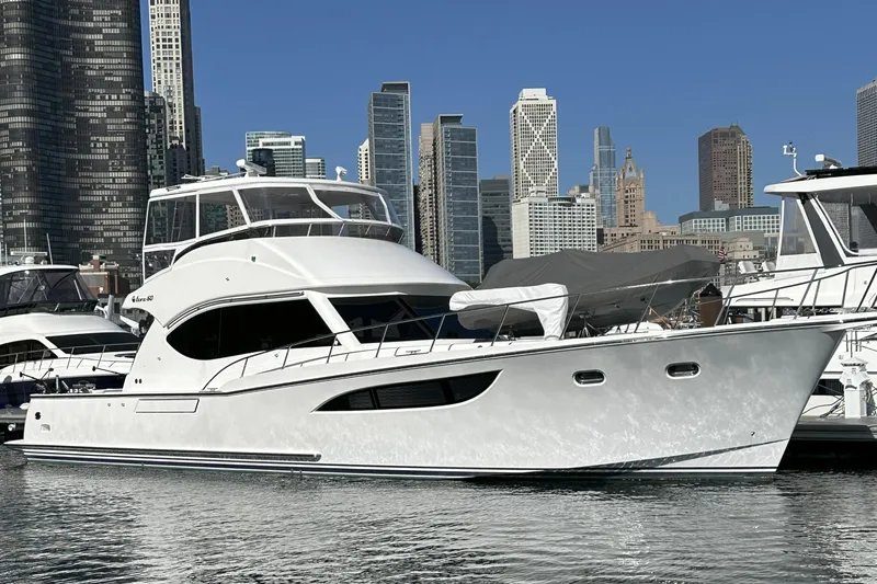 Resiliensea Yacht Photos Pics 2014 Nordhavn 60 Toro Convertible yacht docked in urban marina with city skyline.