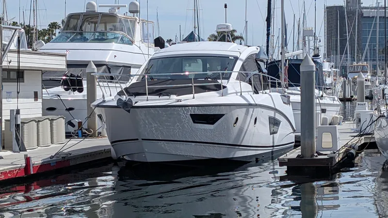 Best Life Yacht Photos Pics 2019 Beneteau GT 46 yacht docked in a marina, surrounded by other boats.