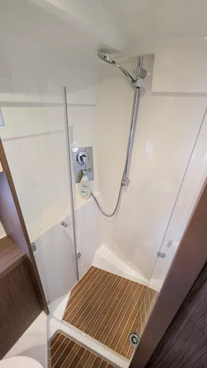 Best Life Yacht Photos Pics Shower area in 2019 Beneteau GT 46 yacht with modern fixtures and wooden flooring.