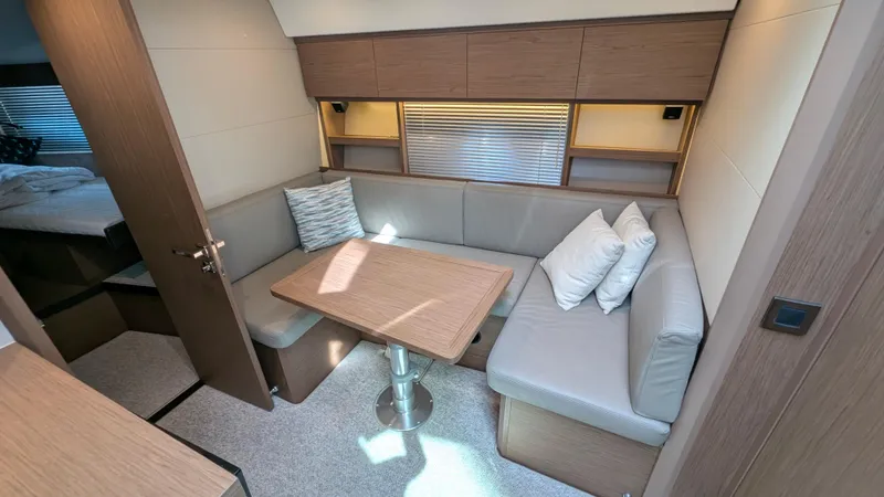 Best Life Yacht Photos Pics 2019 Beneteau GT 46 yacht interior with cozy seating and wooden table.