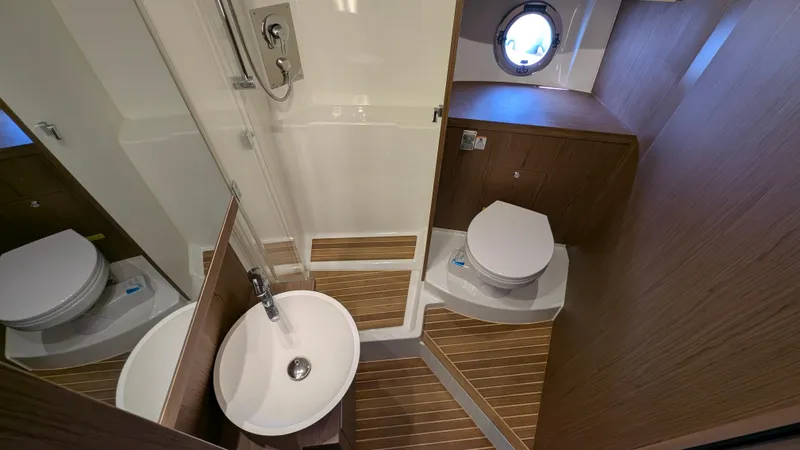 Best Life Yacht Photos Pics 2019 Beneteau GT 46 yacht bathroom with modern fixtures and wooden accents.
