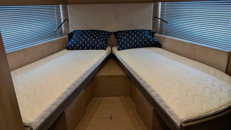 Best Life Yacht Photos Pics Twin beds in 2019 Beneteau GT 46 yacht cabin with blue pillows and blinds.
