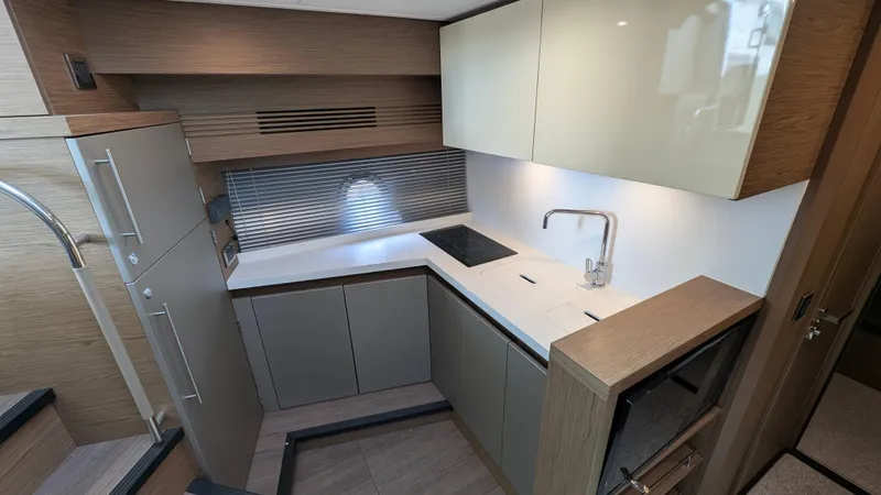 Best Life Yacht Photos Pics Modern kitchen interior of 2019 Beneteau GT 46 yacht with sleek cabinetry and fixtures.