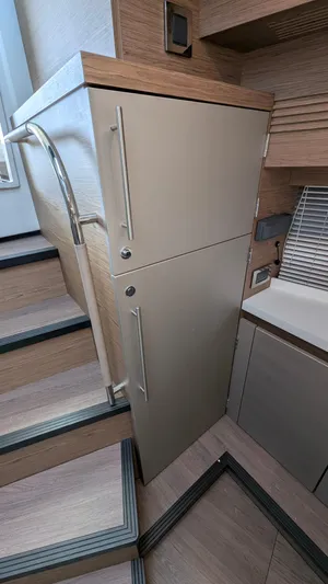 Best Life Yacht Photos Pics 2019 Beneteau GT 46 interior, featuring modern cabinetry and sleek design near staircase.