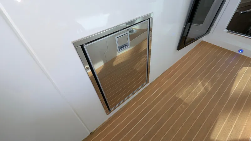 Best Life Yacht Photos Pics Beneteau GT 46 2019 yacht interior with sleek wooden flooring and stainless steel hatch.