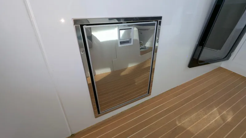 Best Life Yacht Photos Pics 2019 Beneteau GT 46 yacht interior with sleek chrome door and wooden flooring.