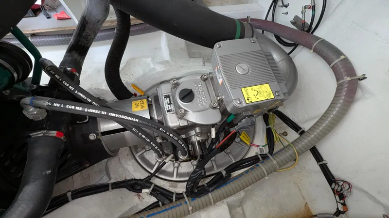 Best Life Yacht Photos Pics Engine compartment of a 2019 Beneteau GT 46 yacht, showcasing mechanical components and hoses.