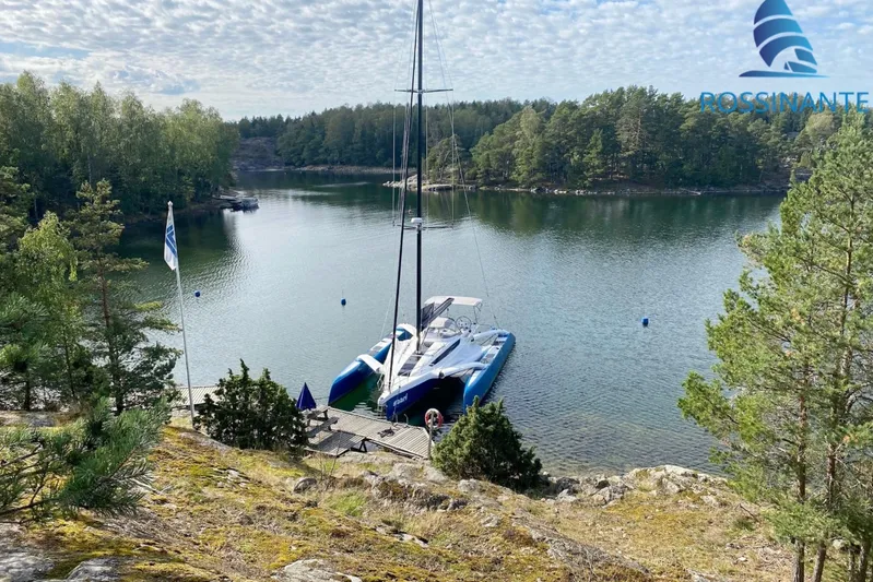  Yacht Photos Pics Sailboat docked in a serene forested lake, Dragonfly 40 model, 2021.