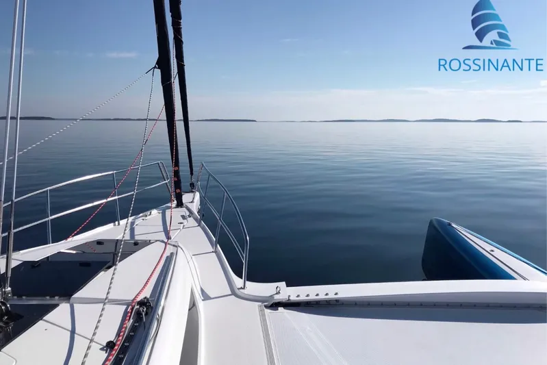  Yacht Photos Pics Sailing on calm waters with a 2021 Dragonfly 40 trimaran, Rossinante logo visible.