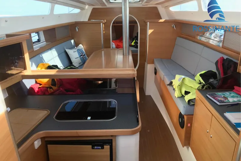  Yacht Photos Pics Interior of 2021 Dragonfly 40 sailboat with modern wood finish and seating area.