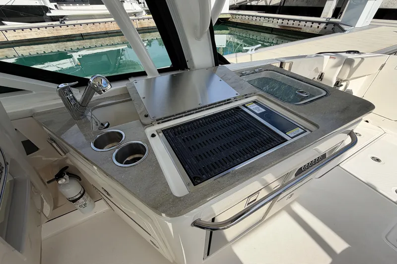  Yacht Photos Pics 2022 Boston Whaler 320 Vantage boat kitchen area with grill and sink.