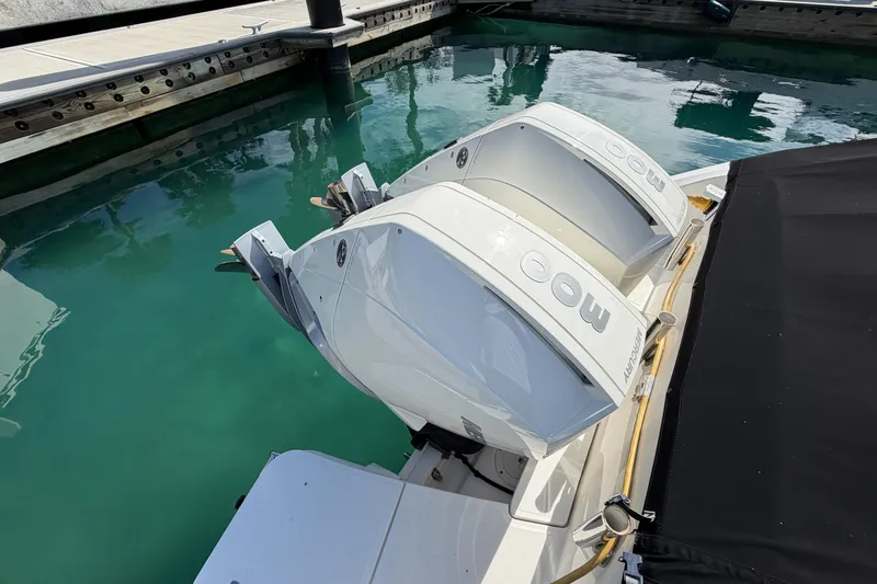  Yacht Photos Pics 2022 Boston Whaler 320 Vantage with twin Mercury outboard engines docked in clear water.