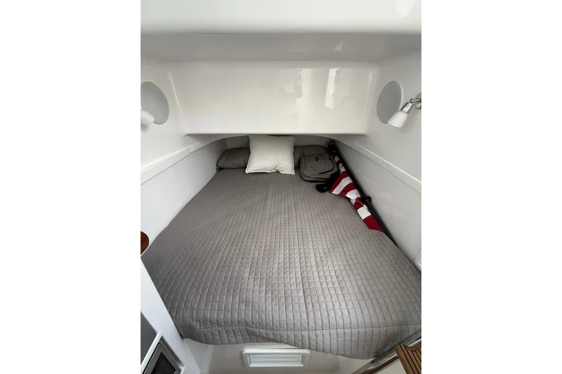  Yacht Photos Pics Cozy cabin interior of 2026 Mag Bay 43 CC with gray bedding and pillows.
