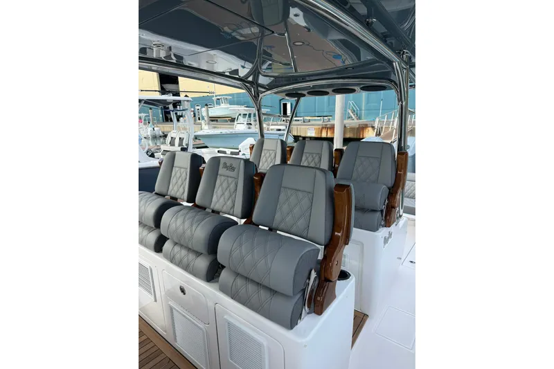  Yacht Photos Pics Luxurious seating on 2026 Mag Bay 43 CC boat, featuring elegant gray upholstery and wood accents.