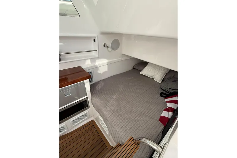  Yacht Photos Pics 2026 Mag Bay 43 CC cabin interior with bed, wood accents, and modern design.