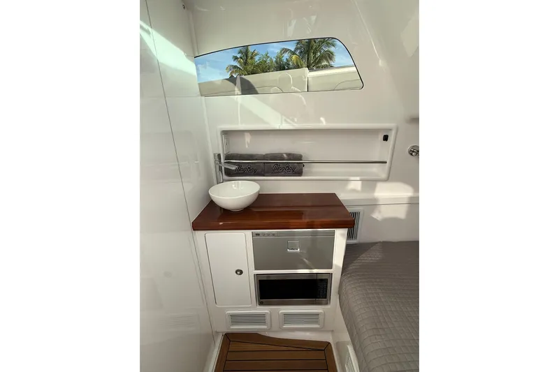  Yacht Photos Pics Interior of 2026 Mag Bay 43 CC boat with modern kitchenette and window view.