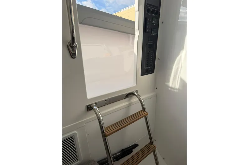  Yacht Photos Pics Interior view of 2026 Mag Bay 43 CC boat, featuring a ladder and control panel.