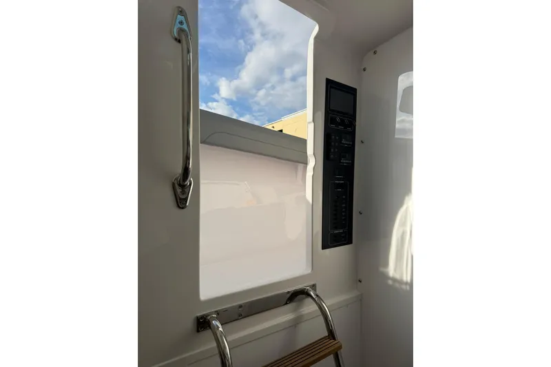  Yacht Photos Pics Interior view of 2026 Mag Bay 43 CC boat, featuring control panel and ladder.