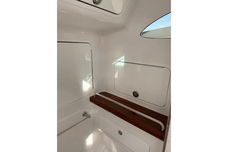  Yacht Photos Pics Interior view of 2026 Mag Bay 43 CC boat, featuring sleek white design and wooden accents.