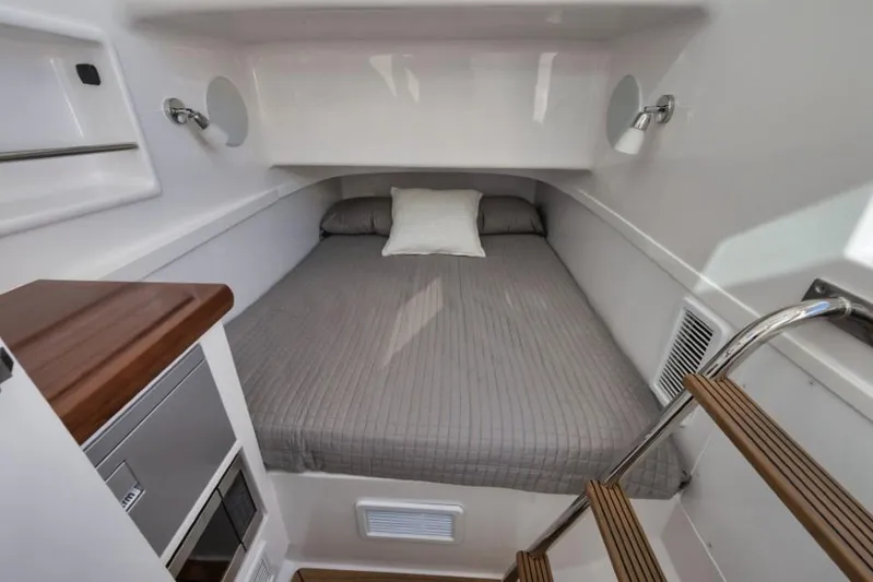  Yacht Photos Pics 2026 Mag Bay 43 CC cabin interior with bed, wooden steps, and modern design.