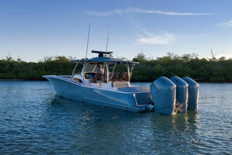  Yacht Photos Pics 2026 Mag Bay 43 CC boat with triple engines on calm water.