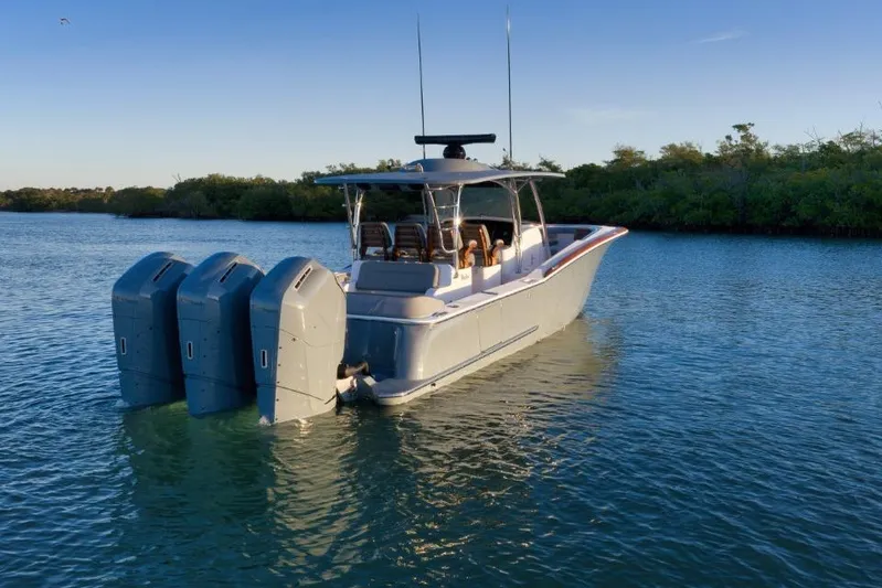  Yacht Photos Pics 2026 Mag Bay 43 CC boat with triple outboard engines on calm water.