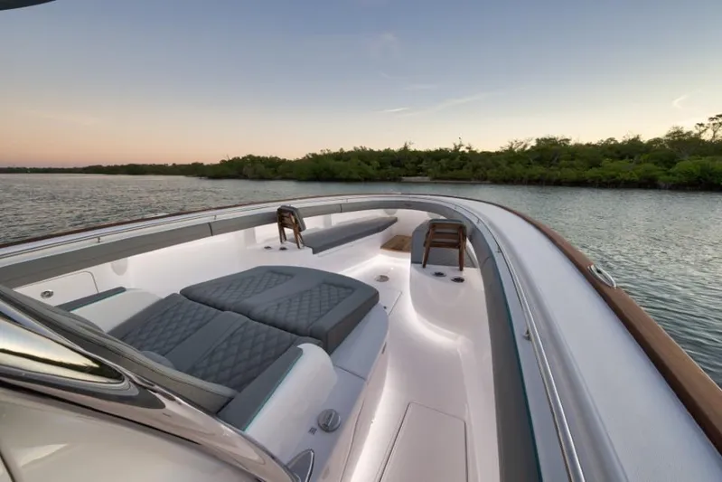  Yacht Photos Pics 2026 Mag Bay 43 CC boat interior with luxurious seating at sunset on calm water.