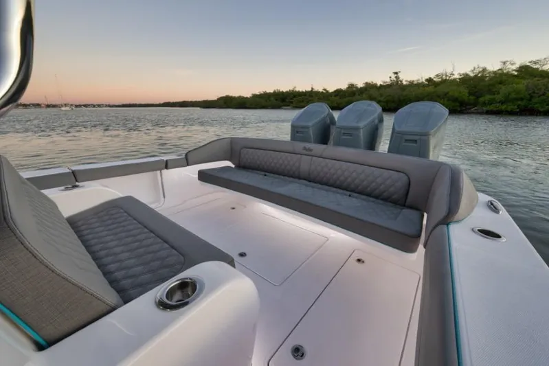  Yacht Photos Pics 2026 Mag Bay 43 CC boat interior with seating and outboard motors at sunset.