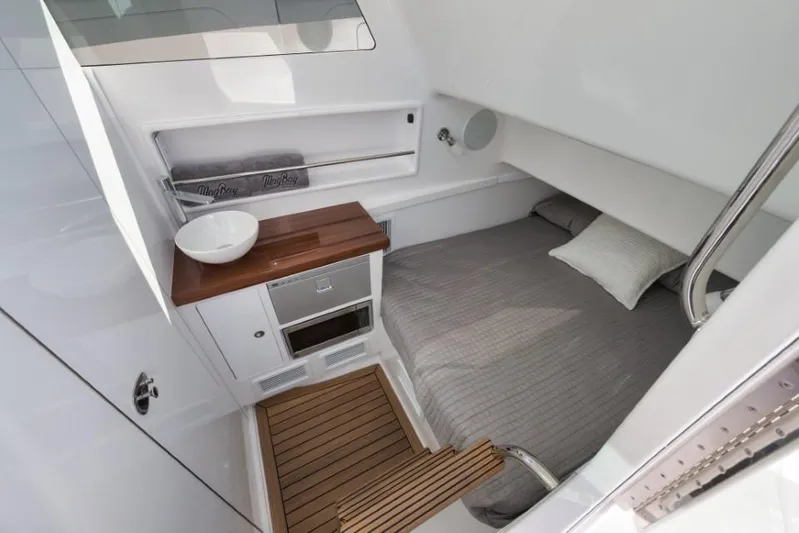  Yacht Photos Pics Interior cabin of 2026 Mag Bay 43 CC boat with bed and kitchenette.