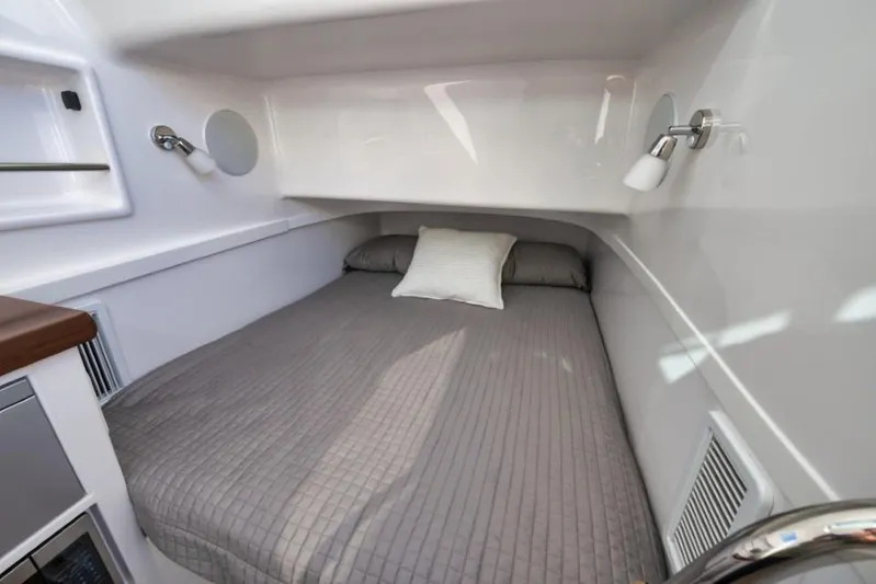  Yacht Photos Pics 2026 Mag Bay 43 CC cabin interior with cozy bed and modern lighting.