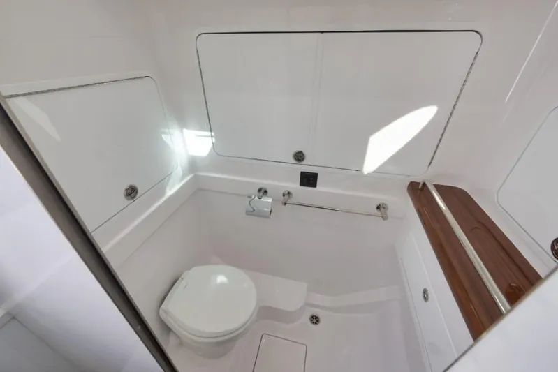  Yacht Photos Pics 2026 Mag Bay 43 CC boat bathroom with sleek white design and wooden accents.
