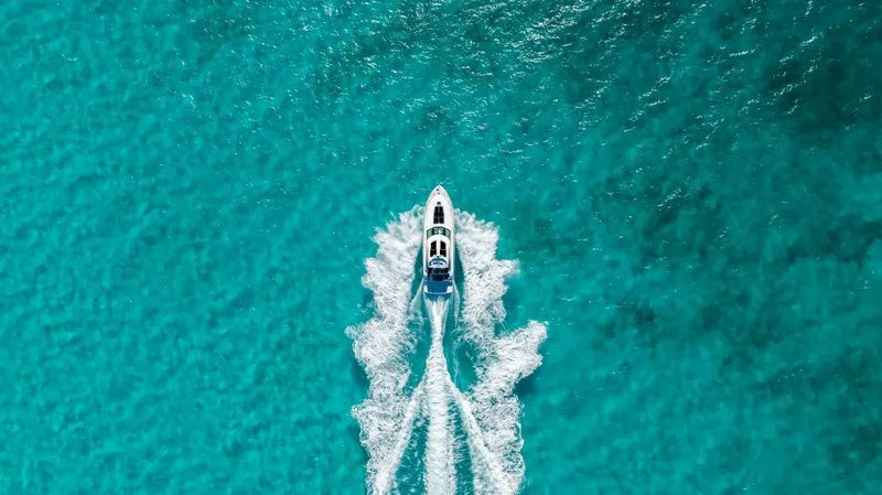 T Yacht Photos Pics Aerial view of 2013 Sea Ray 470 Sundancer cruising on turquoise water.