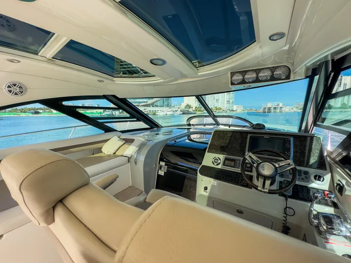 T Yacht Photos Pics Luxurious interior of 2013 Sea Ray 470 Sundancer yacht with modern helm and panoramic windows.