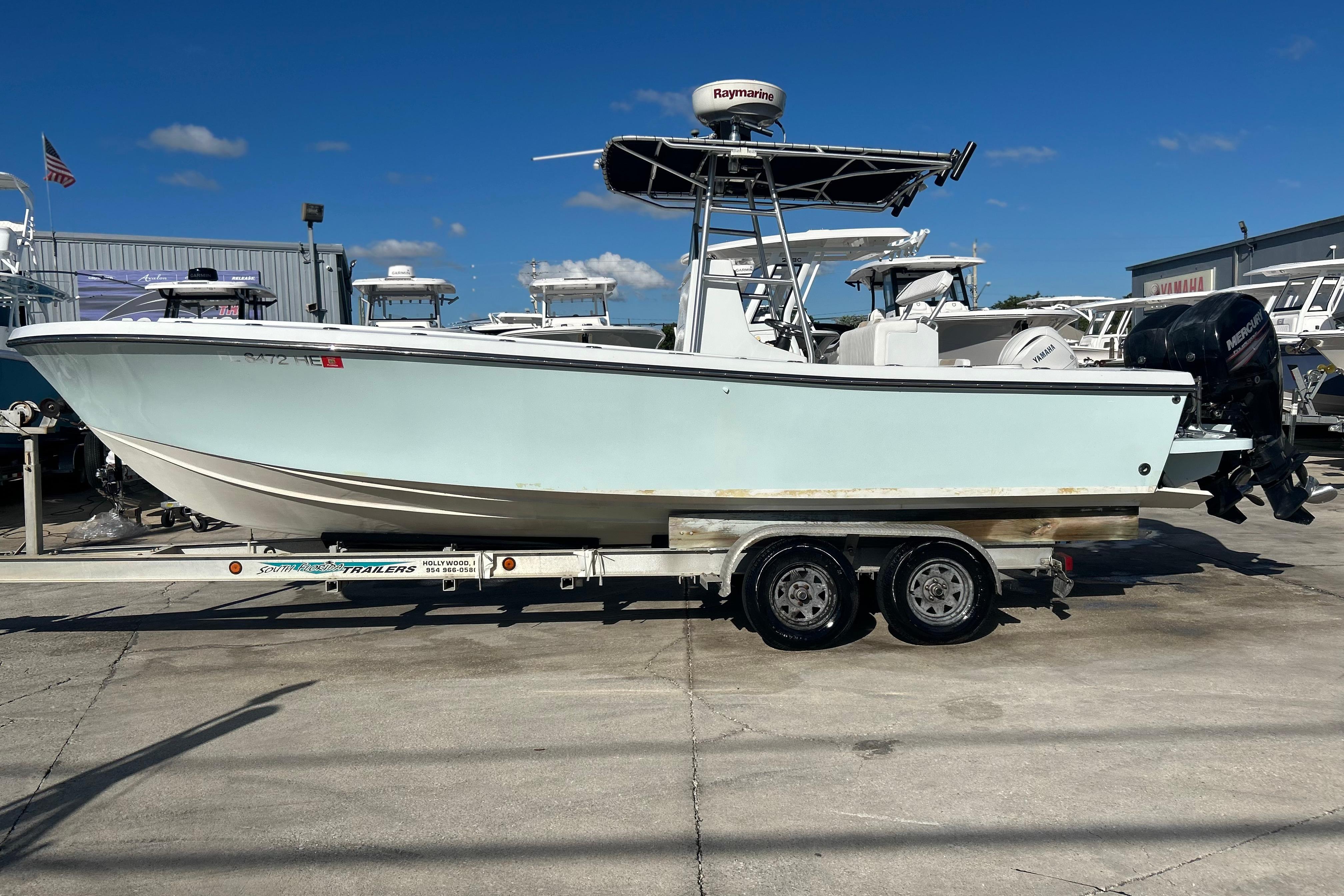 1991 Contender 25 Open boat on trailer, displayed outdoors under clear blue sky.