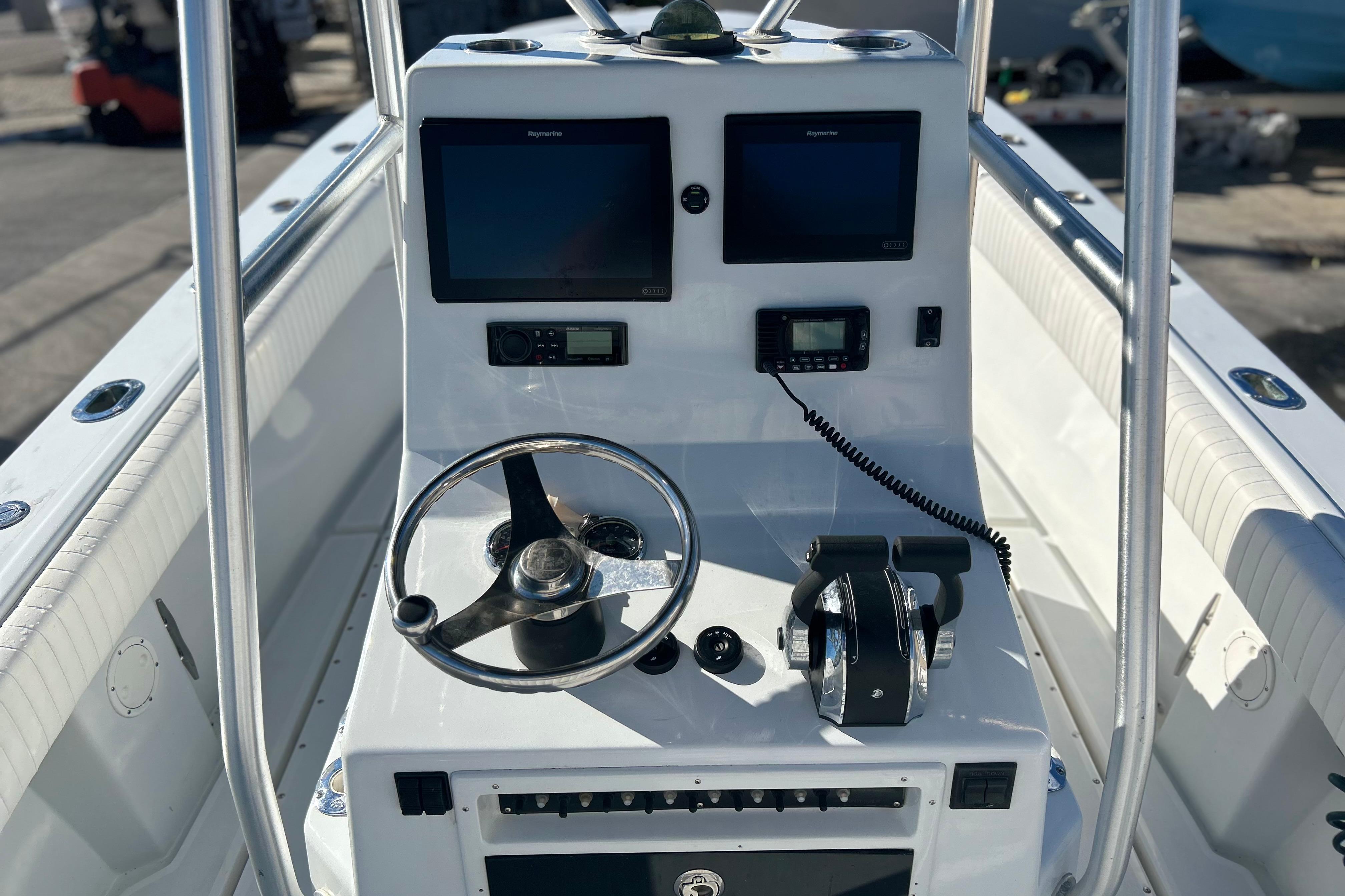 1991 Contender 25 Open boat console with steering wheel, dual screens, and controls.