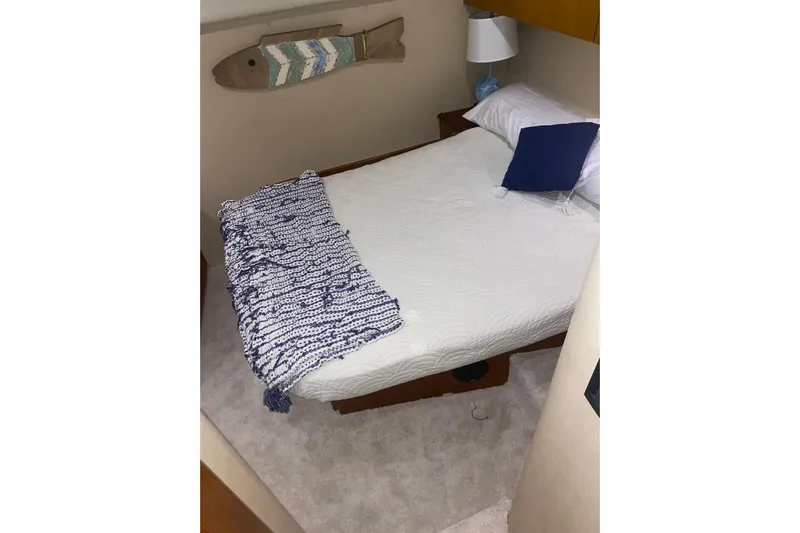  Yacht Photos Pics Cozy bedroom in 2002 Ocean Yacht Super Sport with nautical decor and plush bedding.