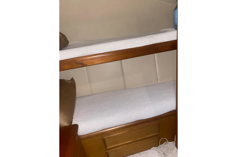  Yacht Photos Pics Bunk beds in 2002 Ocean Yacht Super Sport cabin, featuring wooden frames and white bedding.