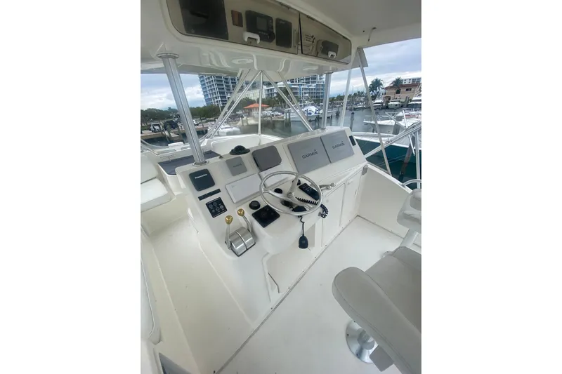  Yacht Photos Pics 2002 Ocean Yacht Super Sport helm with navigation equipment and marina view.