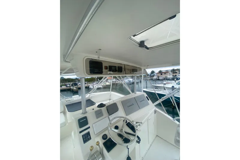  Yacht Photos Pics 2002 Ocean Yacht Super Sport helm with Garmin navigation, docked at marina.